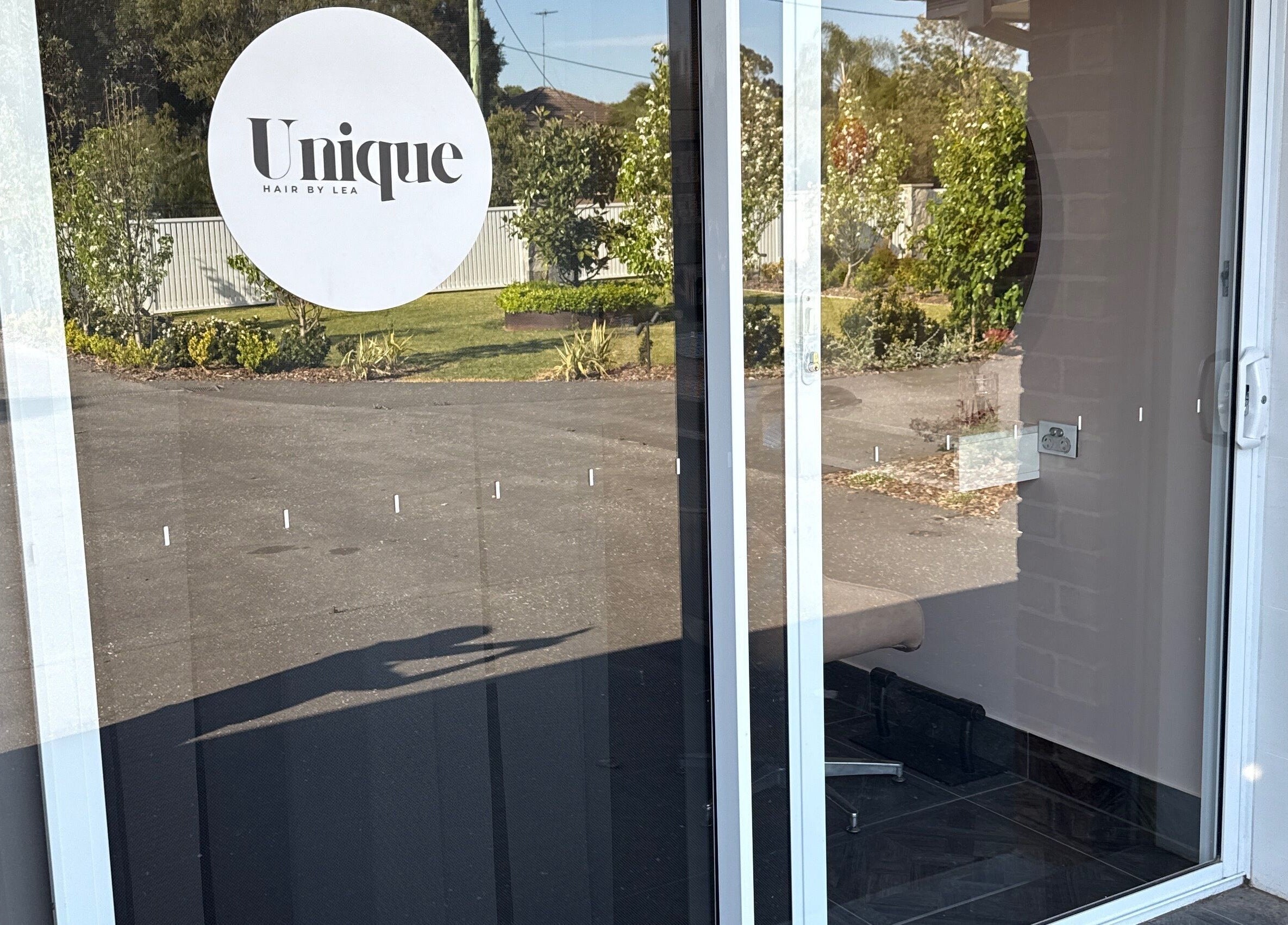 Entrance of Unique Hair by Lea in Catherine Field, New South Wales, AU, showcasing a sleek modern design.