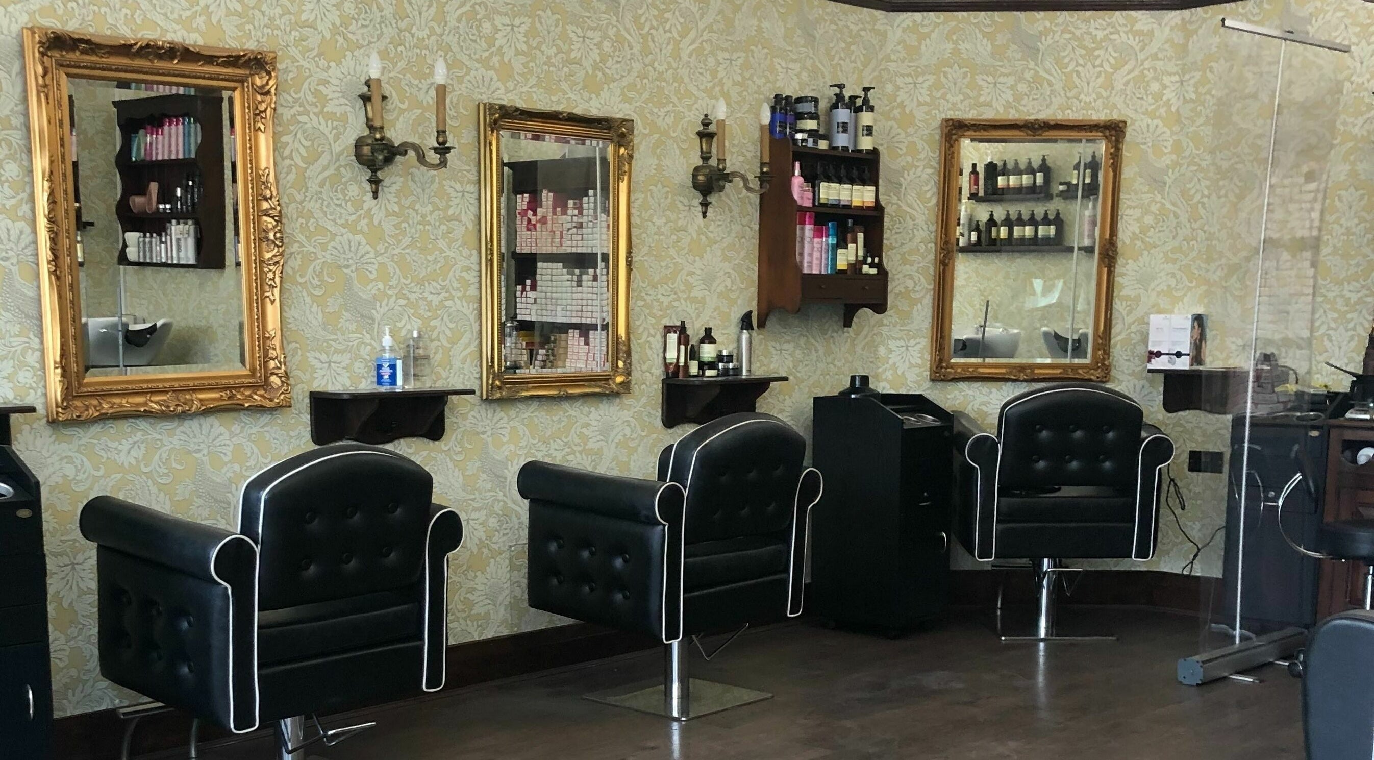 Elegant salon setup at The Living Room Hairdressing in Shrewsbury, England, GB with stylish chairs and mirrors.
