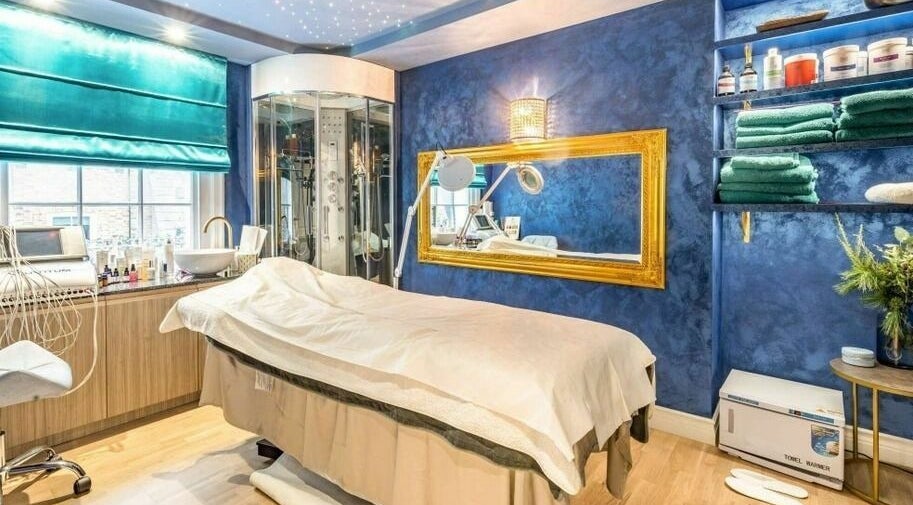 Luxurious spa room at Medusa 622, London, England, GB with blue walls, elegant decor, and treatment bed.