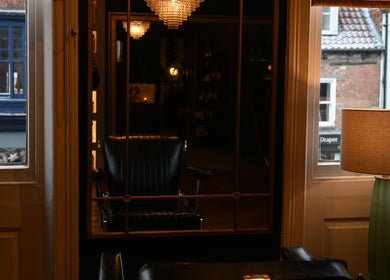 Elegant interior view at Regents of Beverley, Beverley, England, GB displaying a classic chair and lamp.