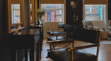 Chic interior of Regents of Beverley salon in Beverley, England, GB, featuring stylish chairs and large mirrors.