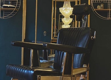 Elegant barber chair and chandelier at Regents of Beverley, Beverley, England, GB.