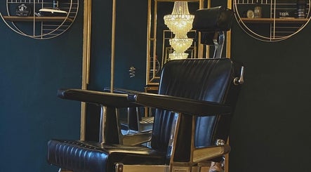 Elegant barber chair and chandelier at Regents of Beverley, Beverley, England, GB.