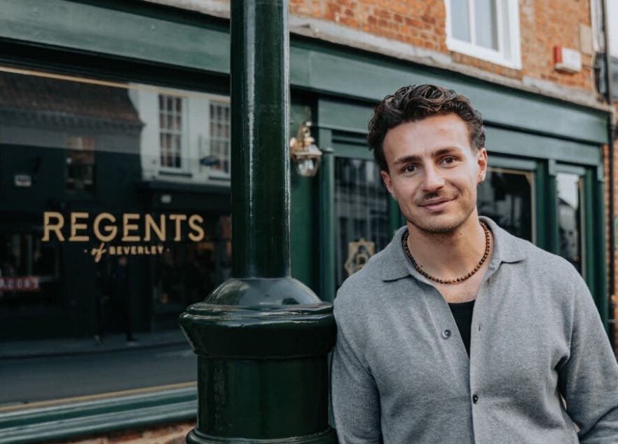 Smiling individual in front of Regents of Beverley venue in Beverley, England, GB, showcasing elegant exterior.