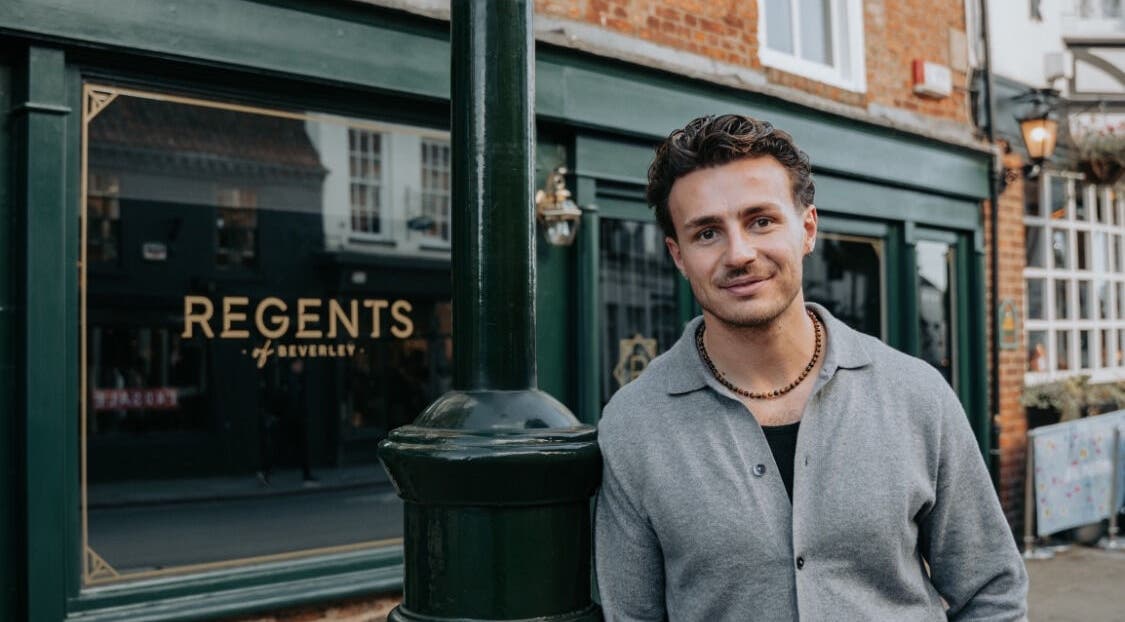 Smiling individual in front of Regents of Beverley venue in Beverley, England, GB, showcasing elegant exterior.