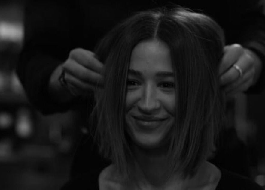 Smiling woman getting hairstyle at Regents of Beverley salon, Beverley, England, GB