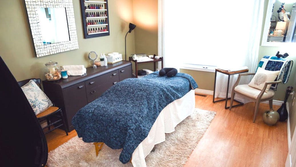 Tranquil massage room at Bronzed Beauty Bar, Lucan, Ontario, CA, featuring a cozy treatment table.