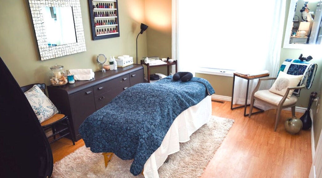 Tranquil massage room at Bronzed Beauty Bar, Lucan, Ontario, CA, featuring a cozy treatment table.