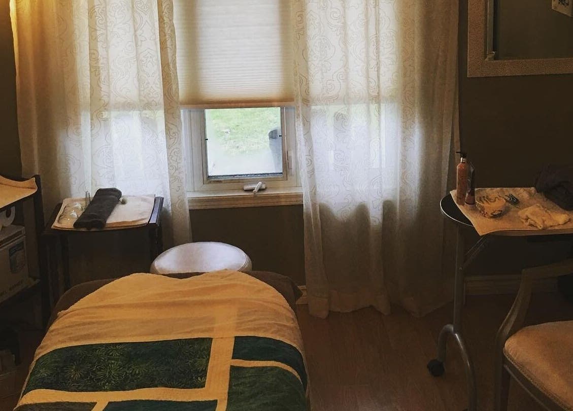 Tranquil spa room at Bronzed Beauty Bar in Lucan, Ontario, CA, featuring a massage table and soothing decor.