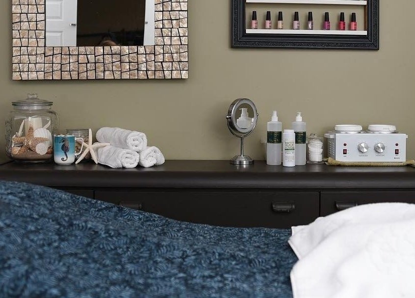 Relaxing treatment room at Bronzed Beauty Bar, Lucan, Ontario, CA with towels and calming decor.