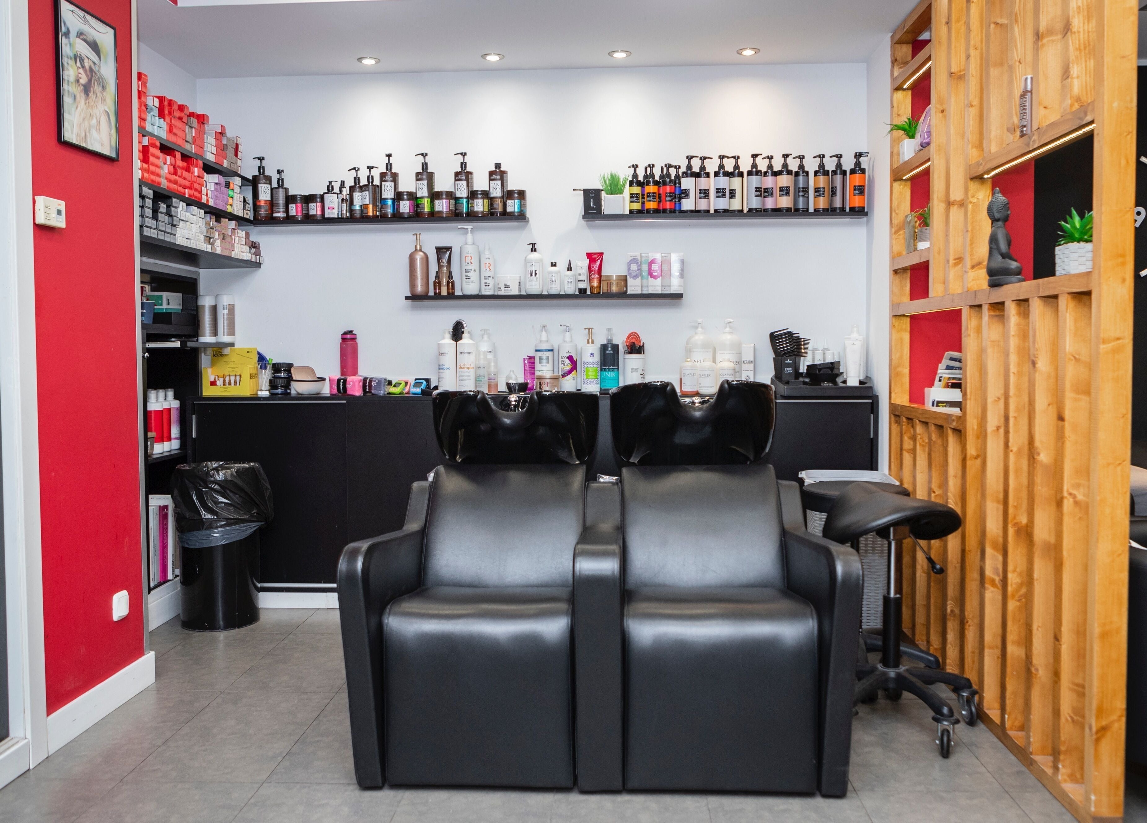 Interior de K Perruquers en Andorra la Vella, mostrando sillas de lavado y productos de belleza profesionales.