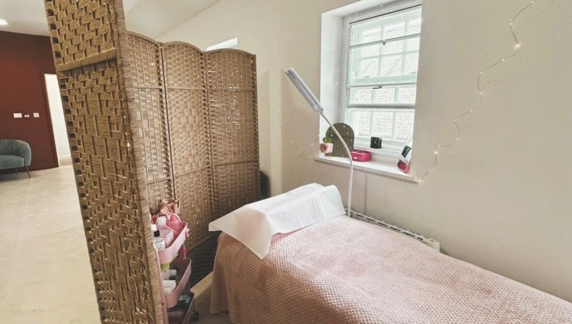 Bright treatment room at PR Lashes, Truro, England, GB, with comfortable bed and ambient lighting.