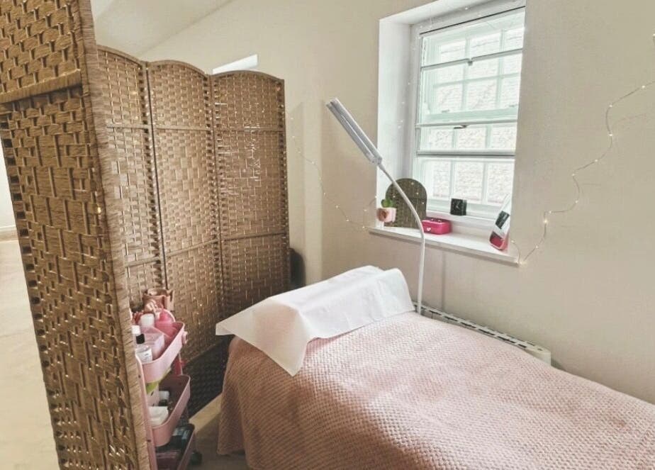 Bright treatment room at PR Lashes, Truro, England, GB, with comfortable bed and ambient lighting.