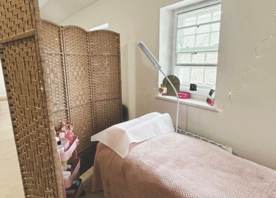 Bright treatment room at PR Lashes, Truro, England, GB, with comfortable bed and ambient lighting.