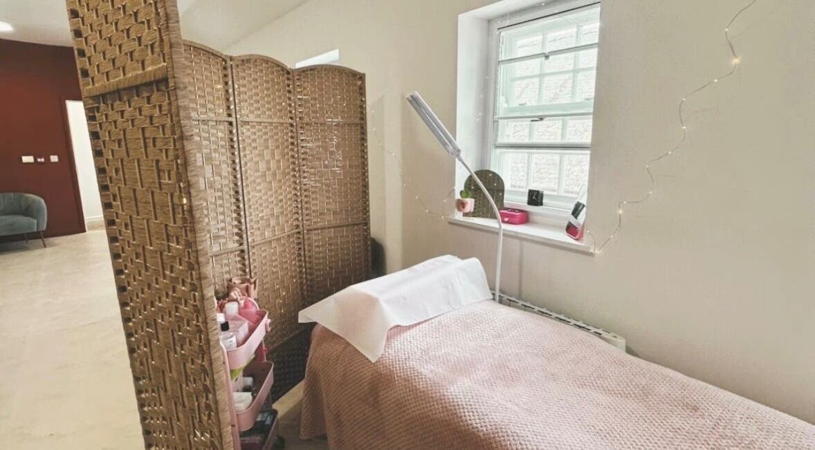 Bright treatment room at PR Lashes, Truro, England, GB, with comfortable bed and ambient lighting.
