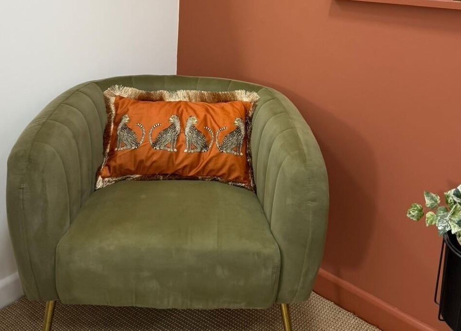 Stylish green chair with animal print cushion at PR Lashes, Truro, England, GB.