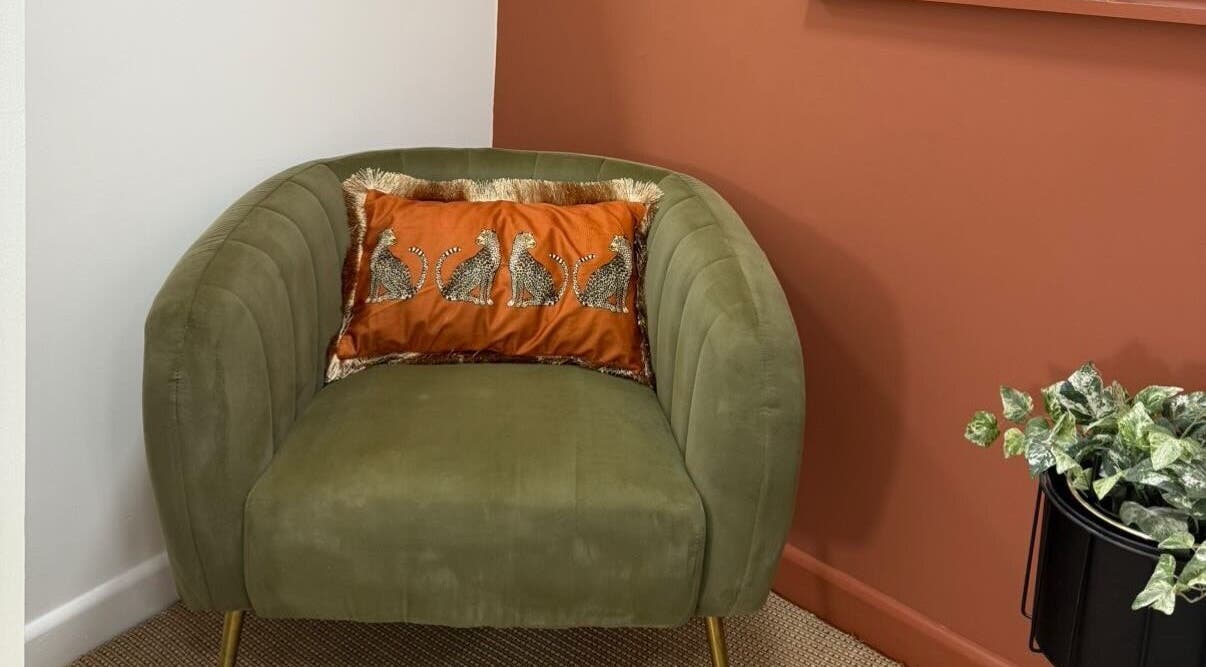 Stylish green chair with animal print cushion at PR Lashes, Truro, England, GB.