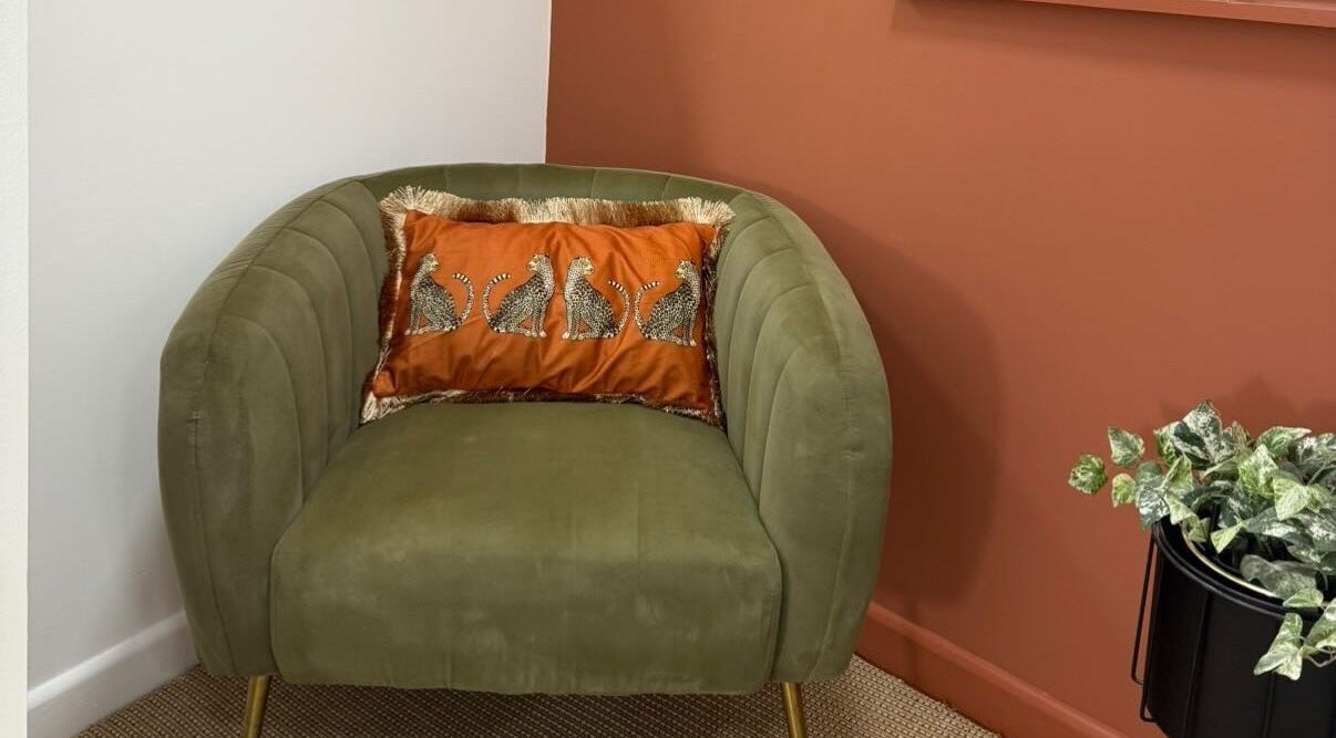 Stylish green chair with animal print cushion at PR Lashes, Truro, England, GB.