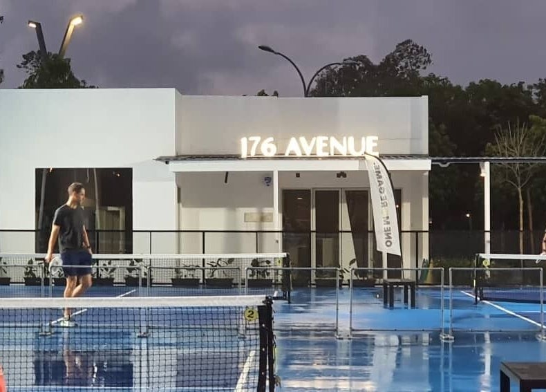 Outdoor sports court at 176 Avenue at KLGCC in Kuala Lumpur featuring two players.