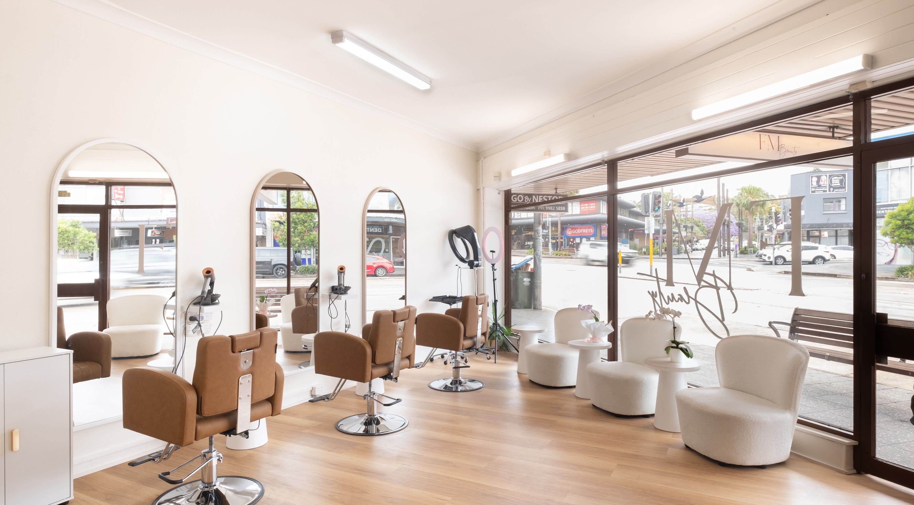 Modern salon interior at FM Beauty Clinic, Dee Why, New South Wales, AU with stylish seating and mirrors.