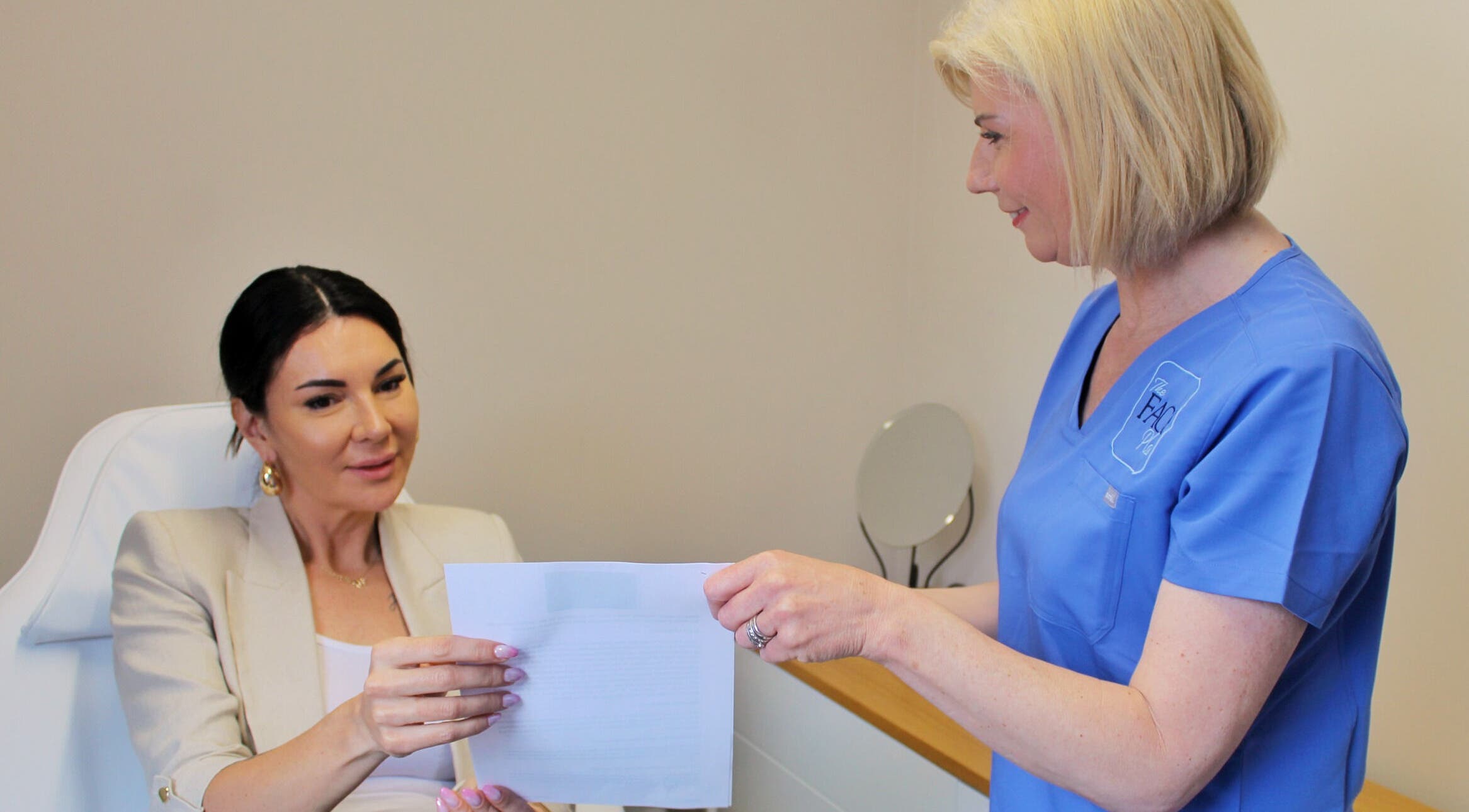 Consultation at The Face Place, Inverness, Scotland, GB. A client discusses skincare services with a professional.
