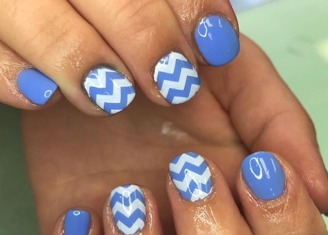 Blue zigzag nail art design at Sandy Beach Aesthetics, Toronto, Ontario, CA offering unique manicure styles.