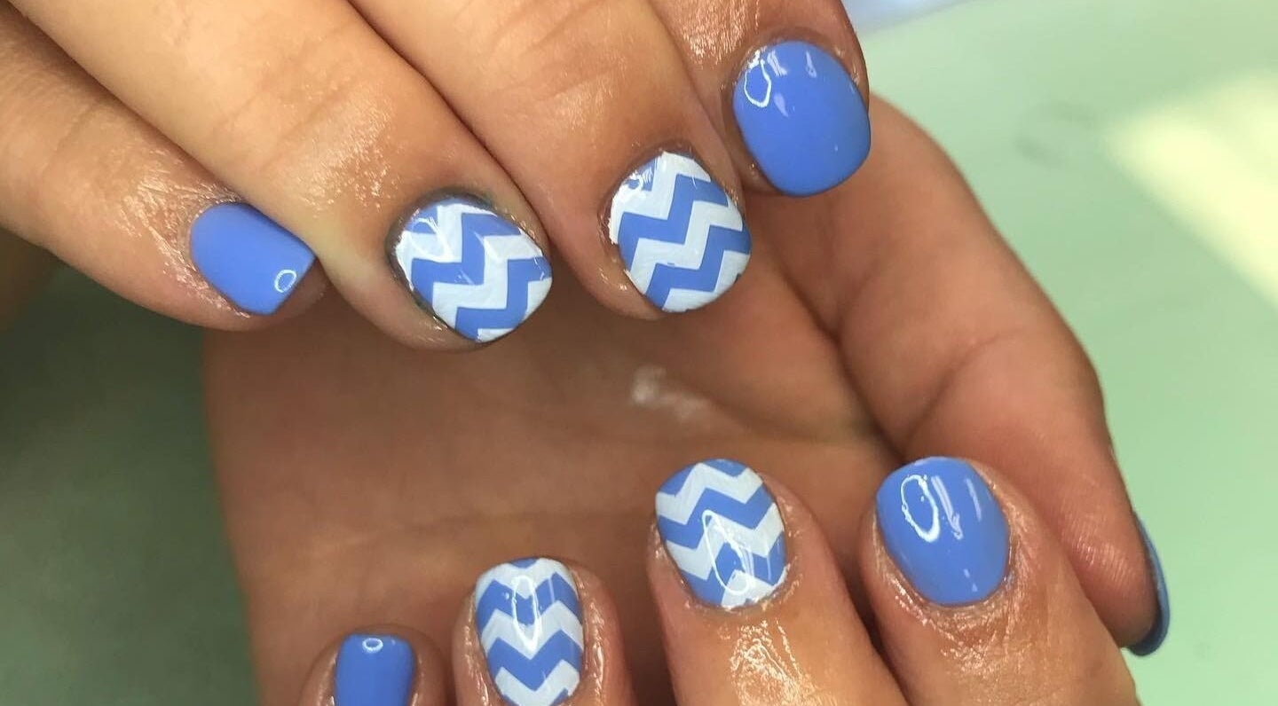 Blue zigzag nail art design at Sandy Beach Aesthetics, Toronto, Ontario, CA offering unique manicure styles.