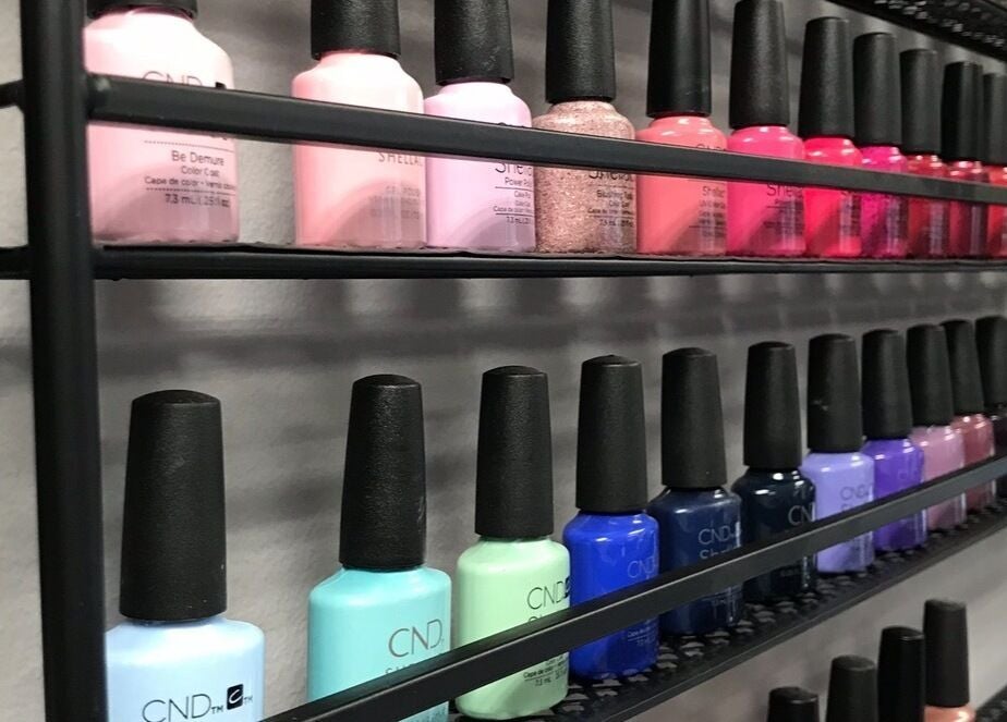 A vibrant nail polish display at Sandy Beach Aesthetics in Toronto, Ontario, CA, showcasing diverse color options.
