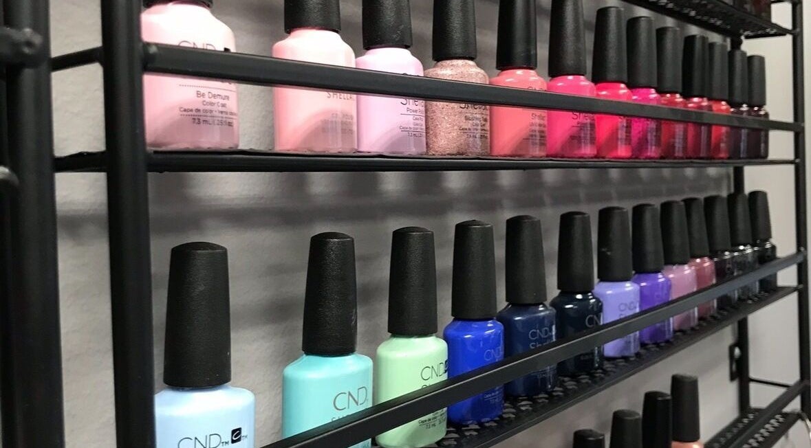 A vibrant nail polish display at Sandy Beach Aesthetics in Toronto, Ontario, CA, showcasing diverse color options.