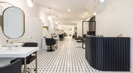 Sleek interior of Loop Beauty salon in Bondi, New South Wales, AU with modern decor and styling stations.