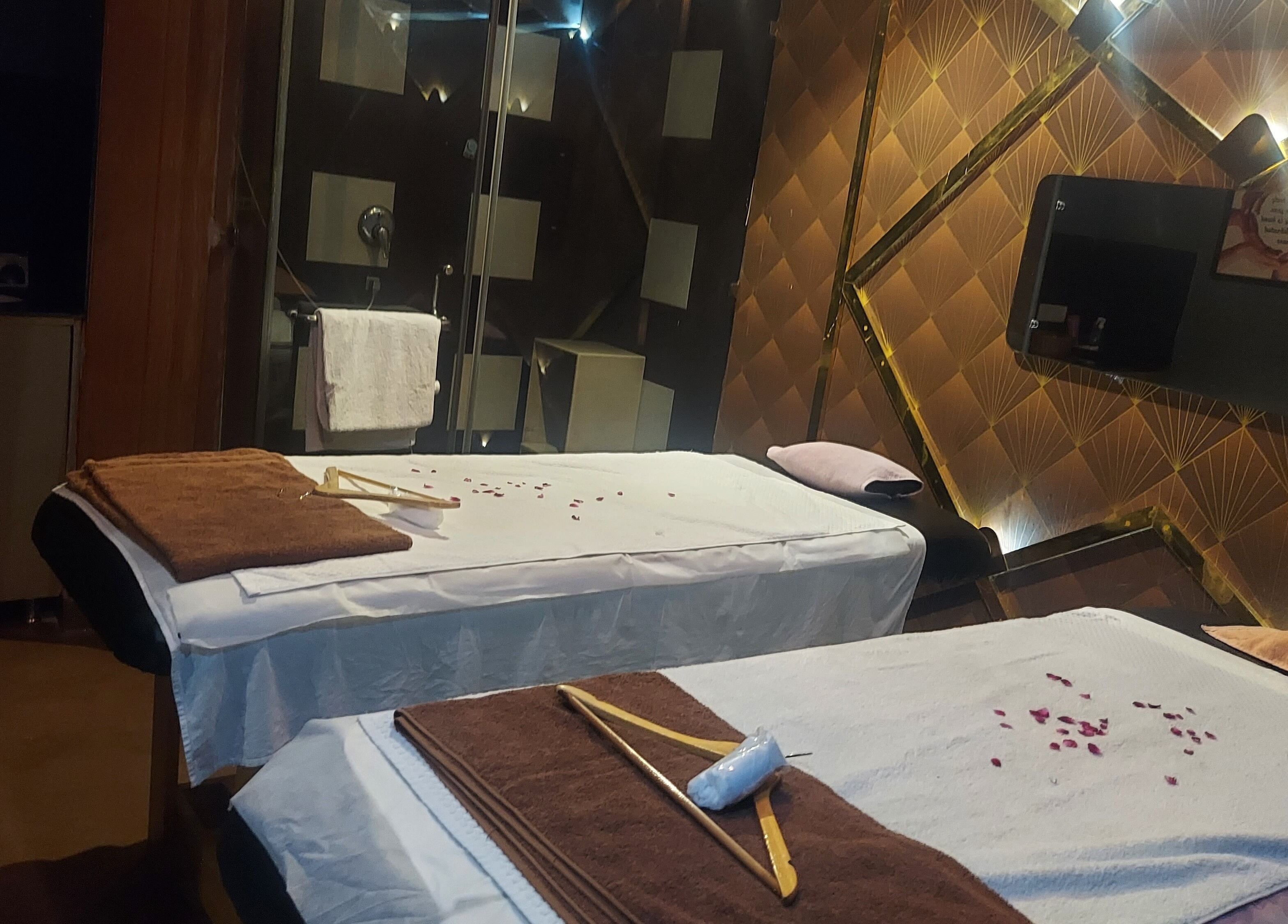 Relaxing massage room at Blue Tree Spa, Ghaziabad, Uttar Pradesh, IN with two beds and calming decor.