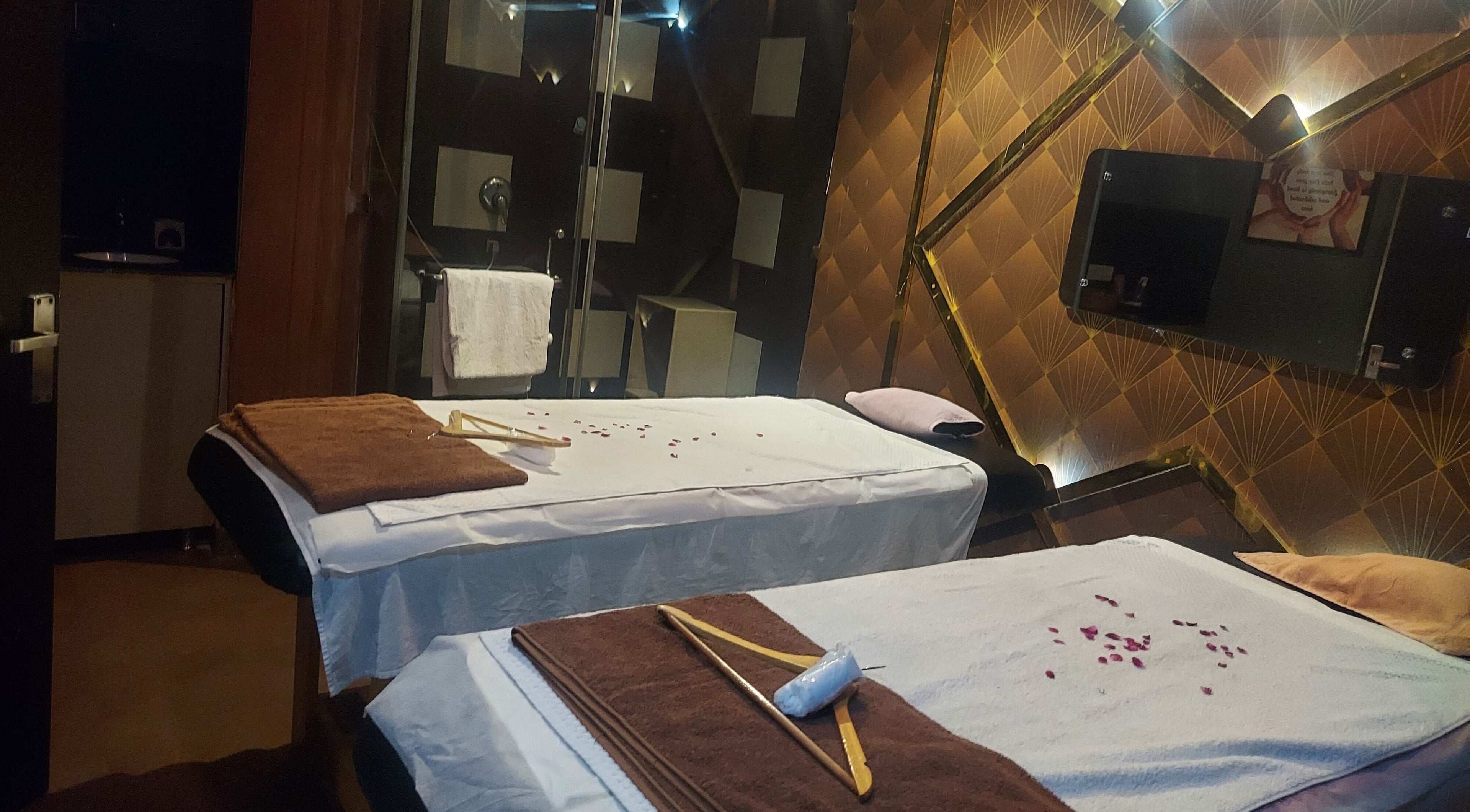 Relaxing massage room at Blue Tree Spa, Ghaziabad, Uttar Pradesh, IN with two beds and calming decor.