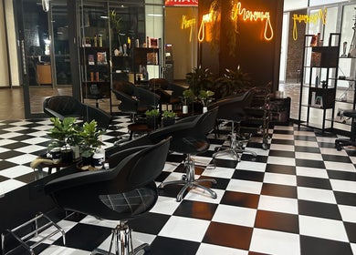 Elegant interior of Mercury Professional Hair and Beauty in Sandton, Gauteng, ZA with stylish black chairs.