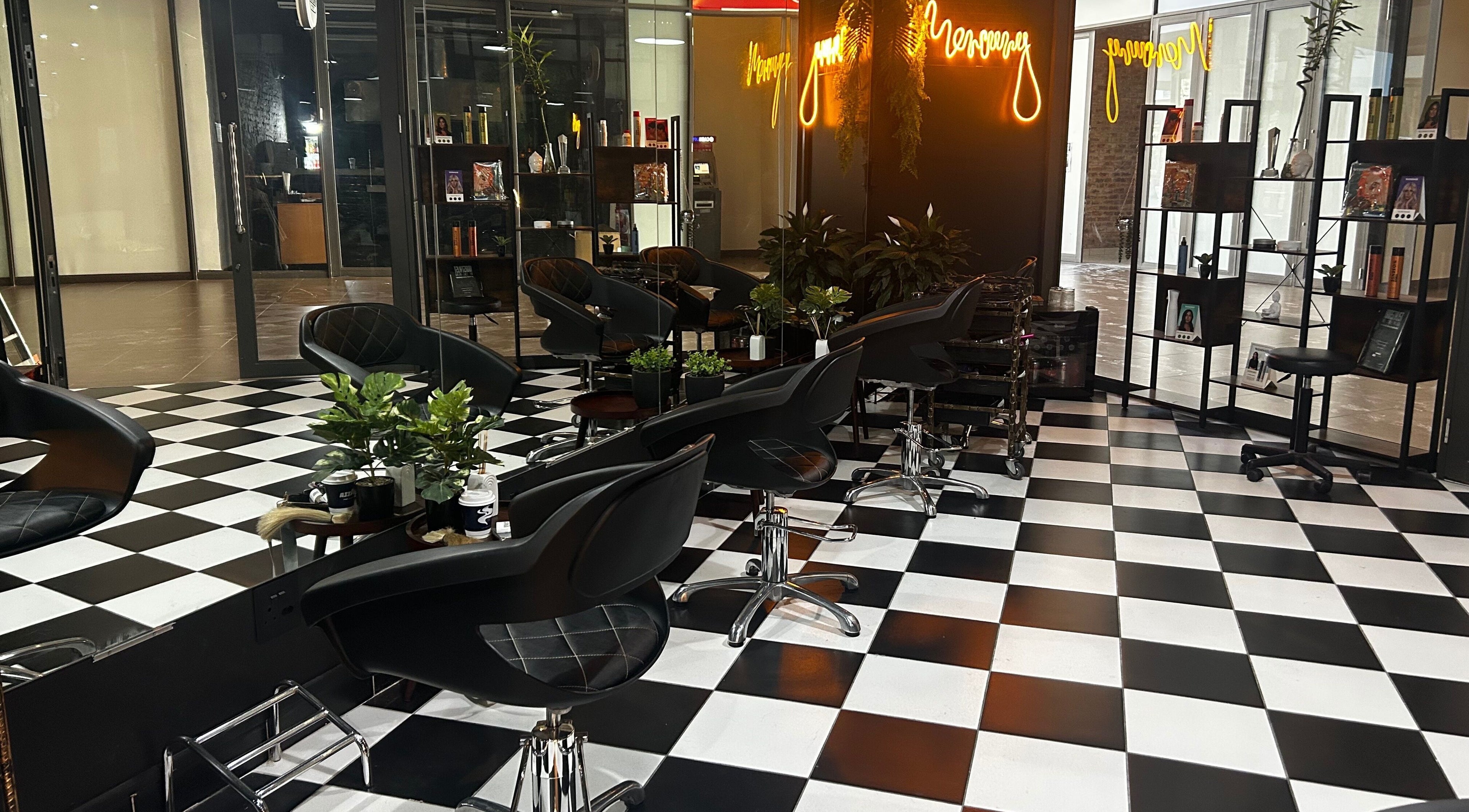 Elegant interior of Mercury Professional Hair and Beauty in Sandton, Gauteng, ZA with stylish black chairs.