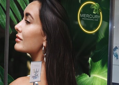 Profile of a woman at Mercury Professional Hair and Beauty in Sandton, Gauteng, ZA with a tropical backdrop.
