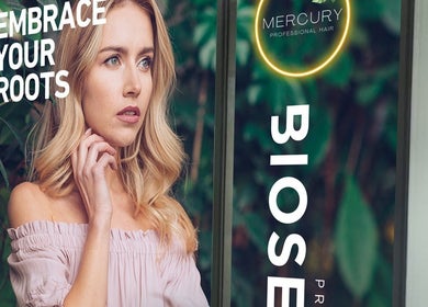 A model at Mercury Professional Hair and Beauty in Sandton, Gauteng, ZA, showcasing elegant blonde hairstyle.