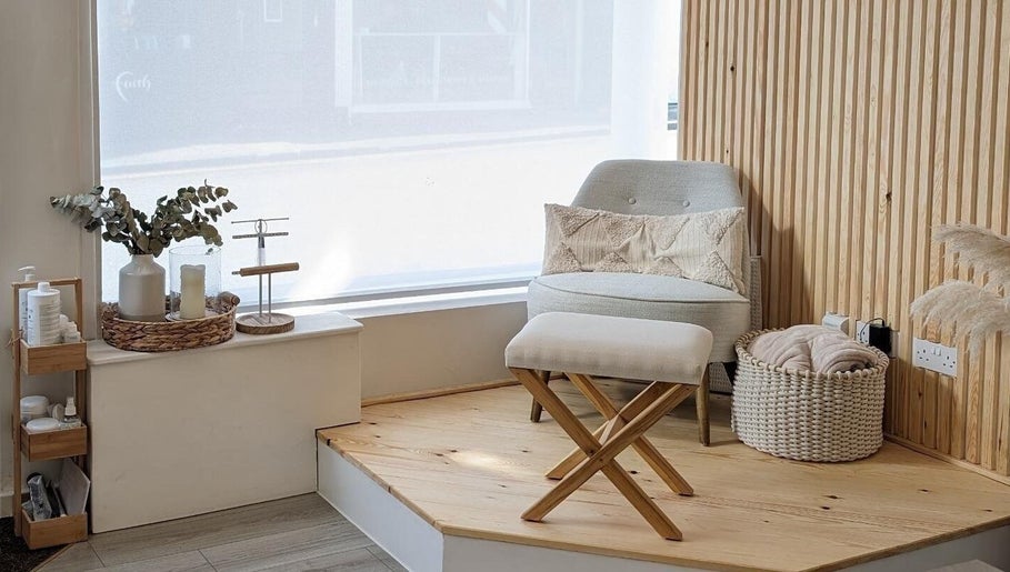 Cozy seating area at Amber Lees, Conwy, Wales, GB, featuring a plush chair and natural decor.