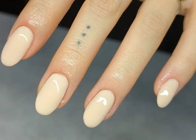 Elegant nude manicure on fingers at Amber Lees, Conwy, Wales, GB, showcasing nail artistry.