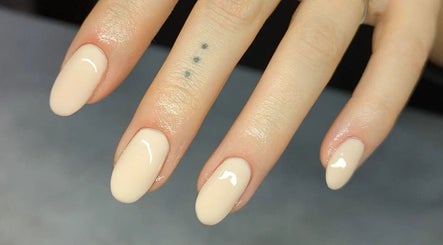 Elegant nude manicure on fingers at Amber Lees, Conwy, Wales, GB, showcasing nail artistry.