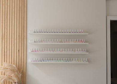 Nail polish display at Amber Lees, Conwy, Wales, GB showcasing a variety of vibrant colors.