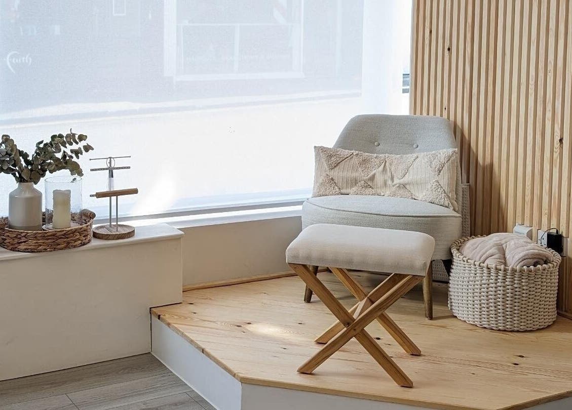 Cozy corner at Amber Lees, Conwy, Wales, GB featuring a plush chair beside a large window.