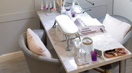 A stylish nail station at Elyshia at E Beautique, Shenfield, England, GB, with plush seating and manicure tools.