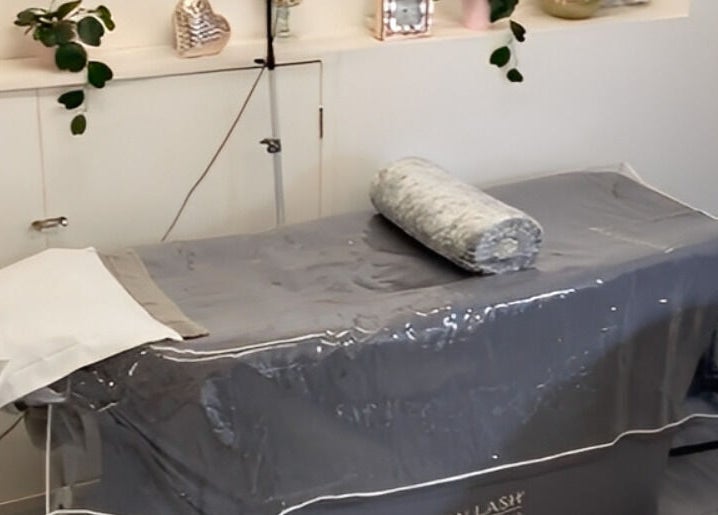 Treatment bed setup at Elyshia at E Beautique, Shenfield, England, GB, offering a serene wellness experience.