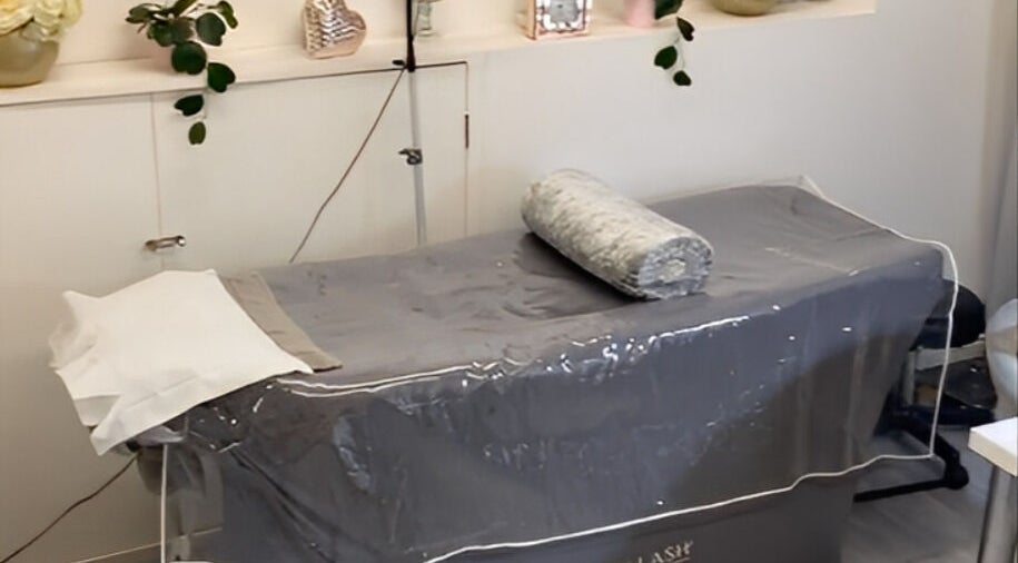 Treatment bed setup at Elyshia at E Beautique, Shenfield, England, GB, offering a serene wellness experience.