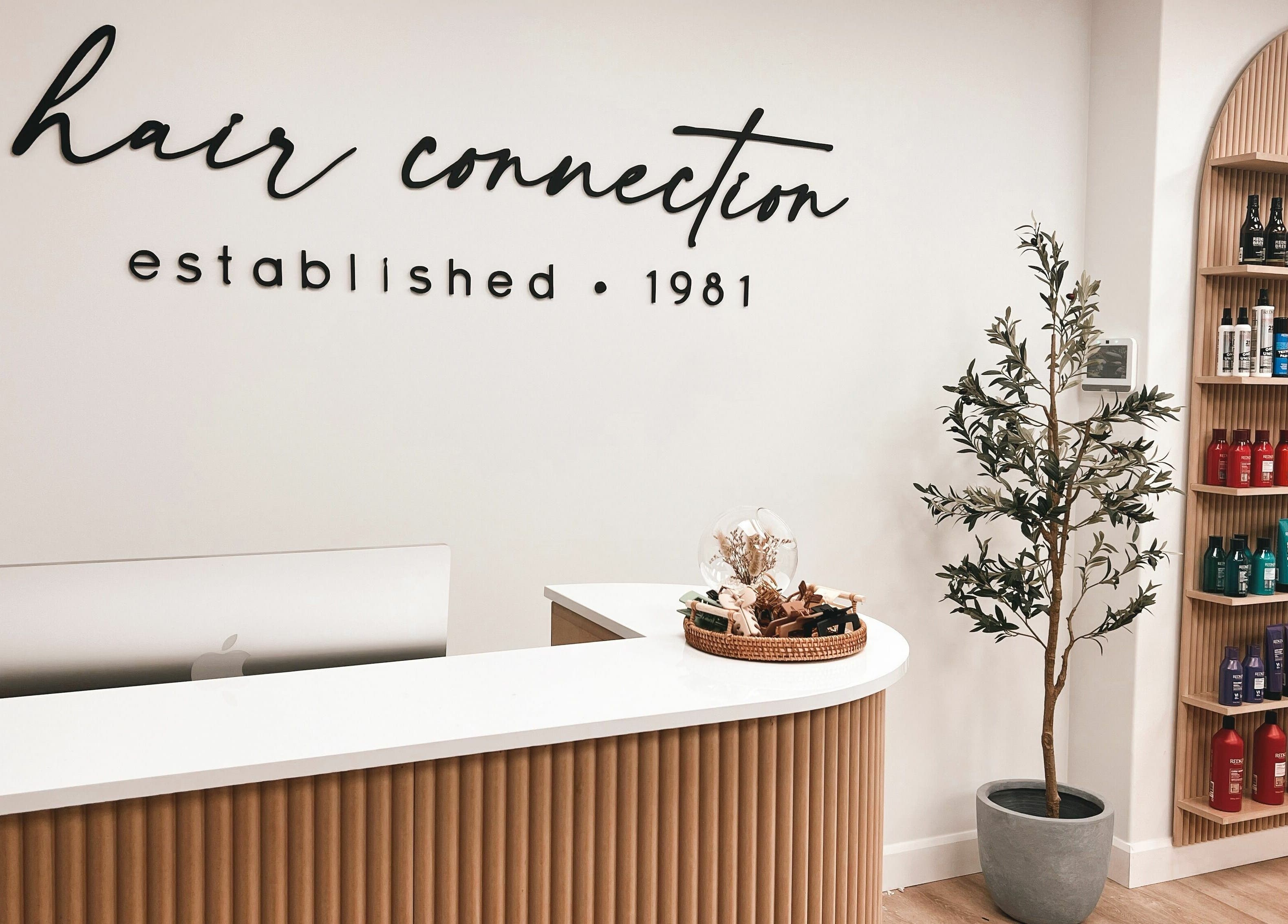 Reception area of Hair Connection Port Elgin, Ontario, CA, featuring a welcoming desk and product displays.