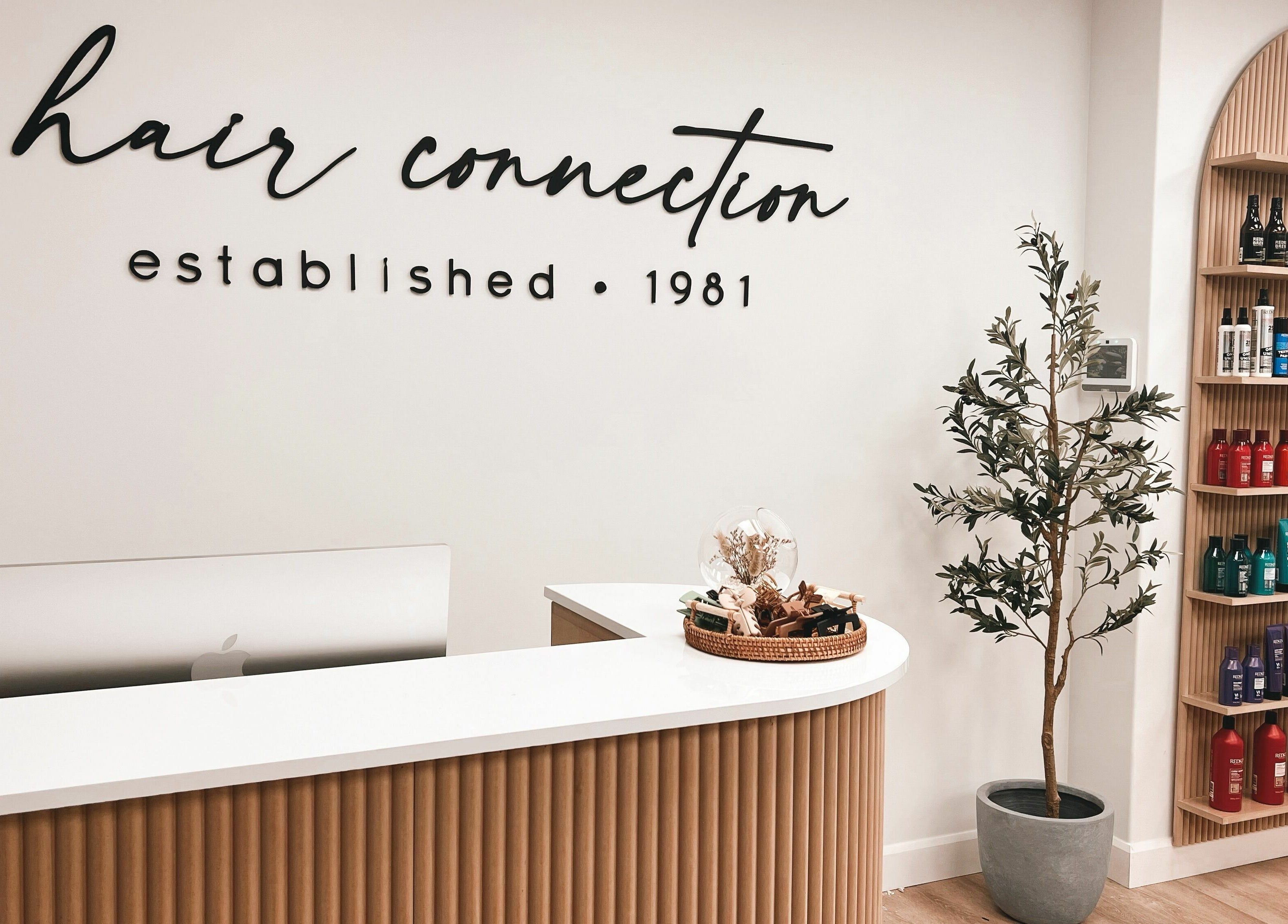 Reception area of Hair Connection Port Elgin, Ontario, CA, featuring a welcoming desk and product displays.