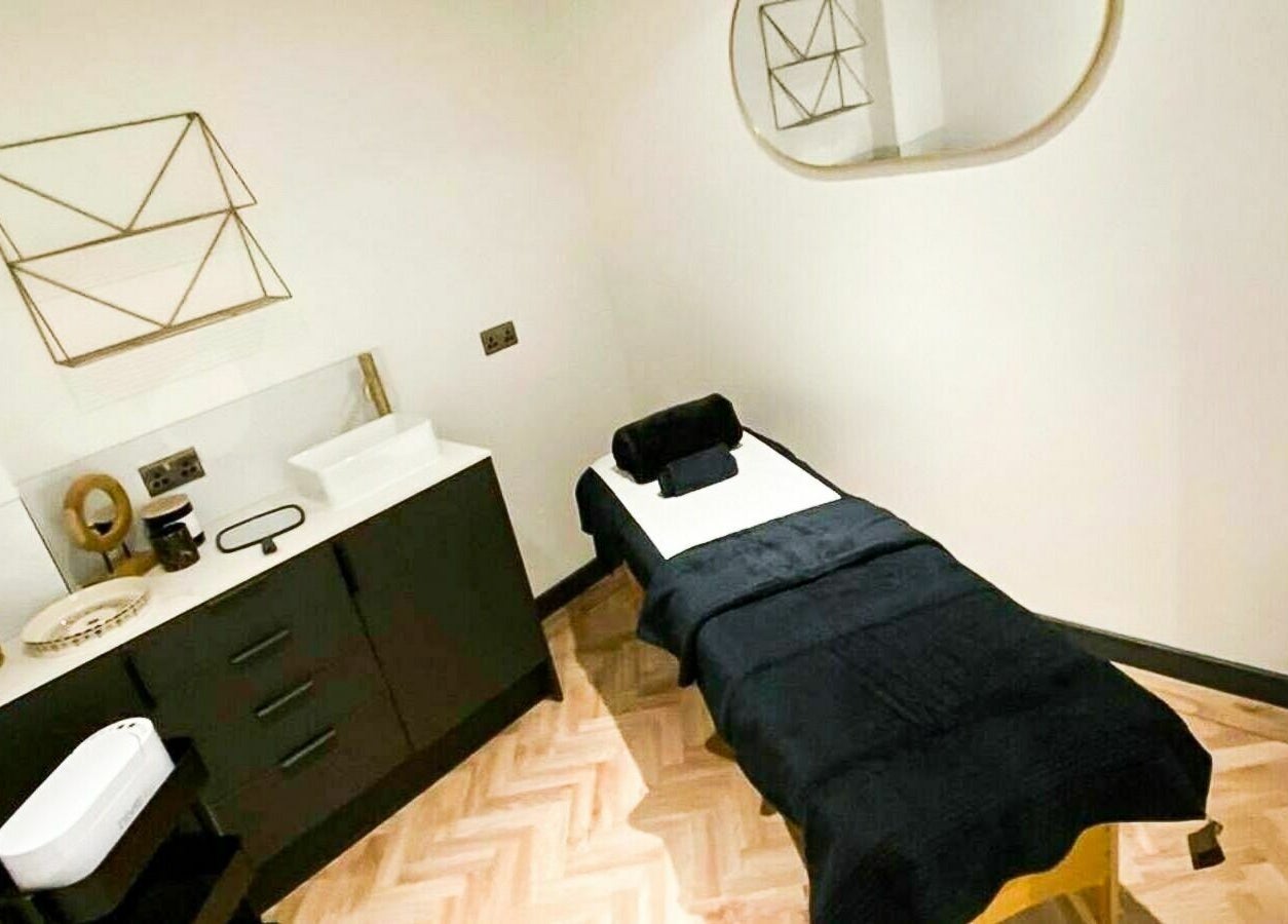 Treatment room at À La Mode, Colchester, featuring a plush massage table and modern decor in Colchester, England, GB.