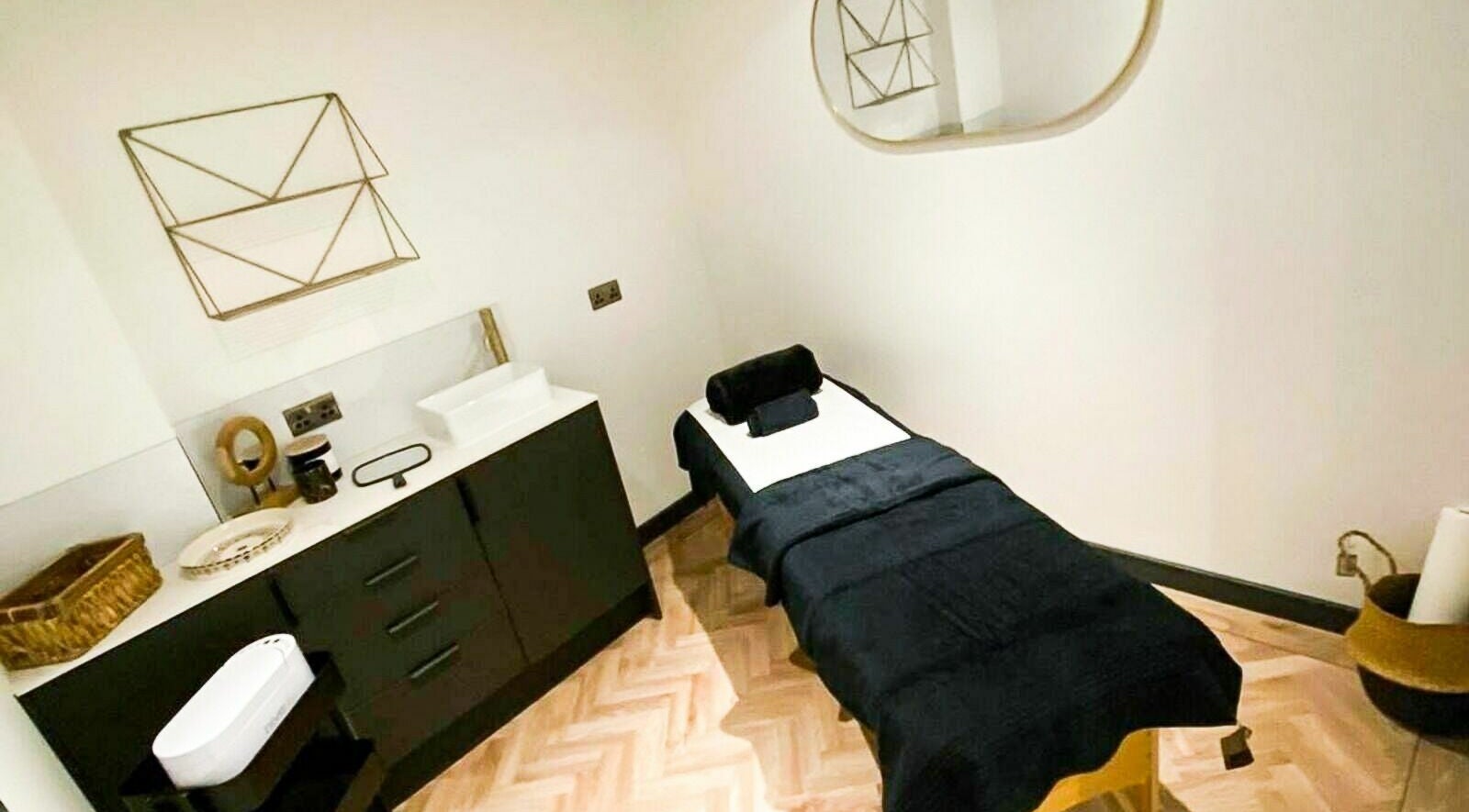 Treatment room at À La Mode, Colchester, featuring a plush massage table and modern decor in Colchester, England, GB.