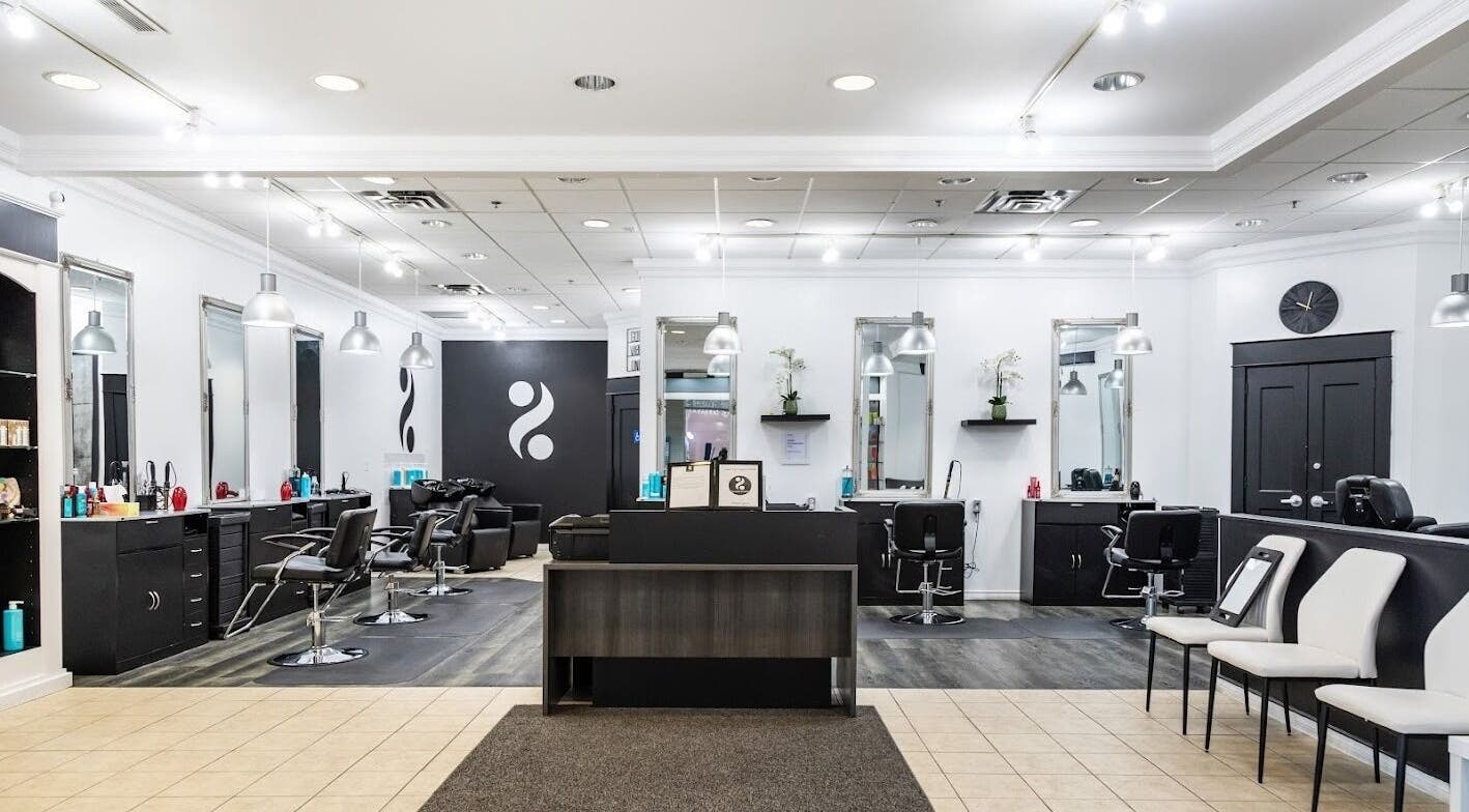 Modern interior of 2 Percent Hairstudio in Windsor, Ontario, CA with sleek design and professional styling chairs.