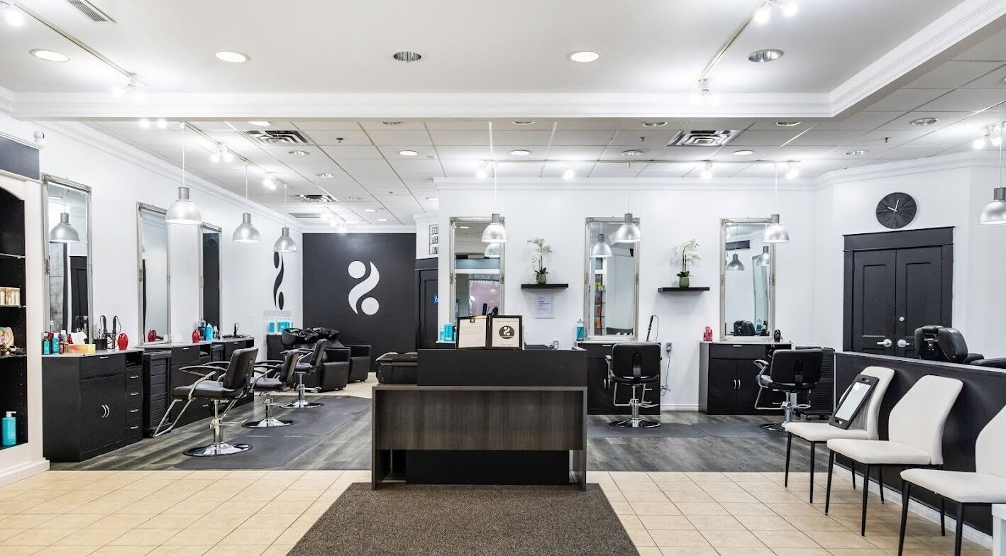 Modern interior of 2 Percent Hairstudio in Windsor, Ontario, CA with sleek design and professional styling chairs.